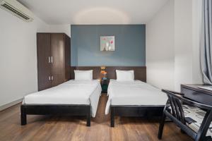 Postel nebo postele na pokoji v ubytování Gold Time Hotel Da Nang