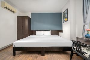 Postel nebo postele na pokoji v ubytování Gold Time Hotel Da Nang