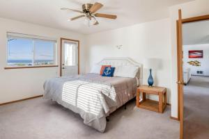 a bedroom with a bed and a ceiling fan at Drop Anchor in Waldport