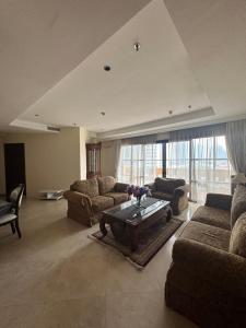 a large living room with couches and a coffee table at Apartemen Kusuma Chandra in Jakarta