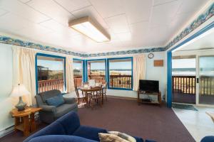 a living room with a view of the ocean at Getaway Oceanfront Lodging in Rockaway Beach