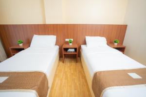 Postel nebo postele na pokoji v ubytování Sundaze Dormitel