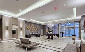 a large living room with a chandelier and a lobby at University of Toronto Downtown Colourful Summer Suites in Toronto