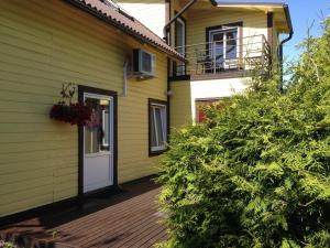 a house that has a tree in front of it at Embrace Apartments in Pärnu