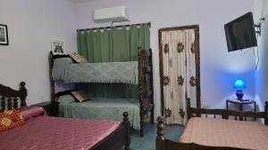 a bedroom with two bunk beds and a tv at Dpto solana in Rosario de la Frontera