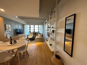 a living room with a table and chairs and a living room at Palko - Oasis in the City in Canberra