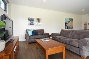 a living room with a couch and a coffee table at Rolling Waves in Pt Leo in Shoreham