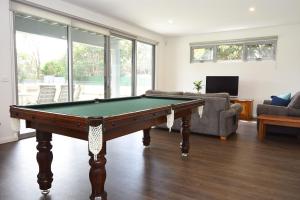 a living room with a pool table in it at Rolling Waves in Pt Leo in Shoreham