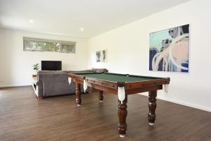 a living room with a pool table and a couch at Rolling Waves in Pt Leo in Shoreham