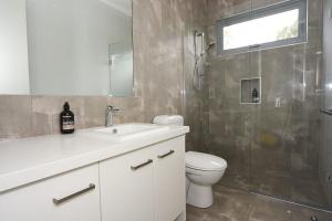 a bathroom with a toilet sink and a shower at Rolling Waves in Pt Leo in Shoreham
