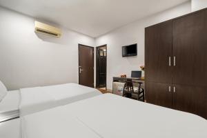 Postel nebo postele na pokoji v ubytování Gold Time Hotel Da Nang