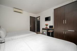 Postel nebo postele na pokoji v ubytování Gold Time Hotel Da Nang