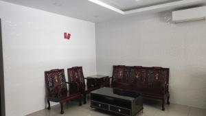 two chairs and a table in a room at BBT Double Storey Balcony Bukit Tinggi Home in Klang