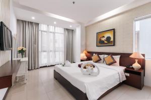 a bedroom with a large bed and a television at Star Hotel and Spa Danang in Danang