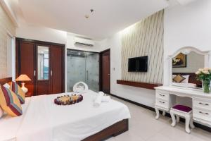 a bedroom with a bed with a cake on it at Star Hotel and Spa Danang in Danang