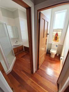 a bathroom with a toilet and a sink at Tauranga - Big, beautiful Villa on the water! in Tauranga