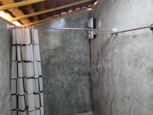 a shower with a shower curtain in a bathroom at Palm Garden Bungalows in Ko Lanta