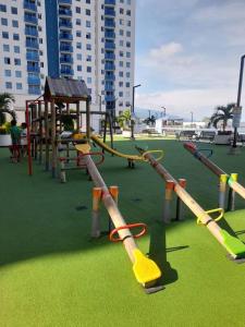 a playground with a slide and a swing set at Hermoso apartamento con piscina ubicado cerca a los principales centros comerciales in Ibagué