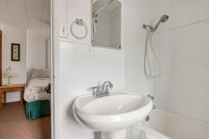 a bathroom with a sink and a shower at The Hamptons in Rockaway Beach +35 photos