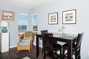 a dining room with a table and chairs at Waters Edge 214 in Lincoln City