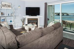 a living room with a couch and a fireplace at Waters Edge 214 in Lincoln City