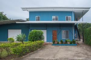 a blue house with plants in front of it at Organic Garden in San José