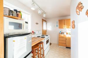 a kitchen with white appliances and a wooden counter top at Whale Pointe in Depoe Bay