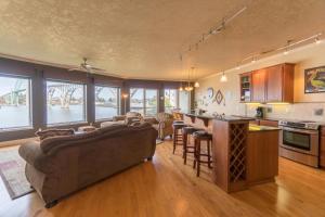 a large living room with a couch and a kitchen at Windward at the Regatta in Newport