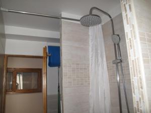 a shower in a bathroom with a shower curtain at Maison de vacances 2 chambres, Wi-Fi, à Saint-Chaffrey - FR-1-762-15 in Saint-Chaffrey +9 photos