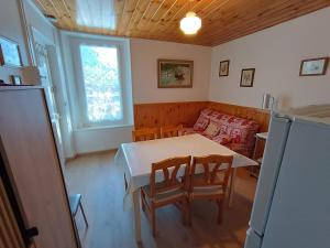a kitchen with a table and chairs and a couch at Appartement Briançon, 2 pièces, 4 personnes - FR-1-762-8 in Briançon