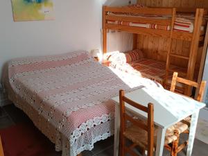 a bedroom with a bed and a desk and bunk beds at Appartement Briançon, 2 pièces, 4 personnes - FR-1-762-8 in Briançon