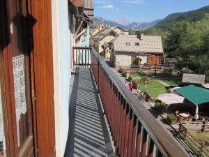 a balcony of a building with a view of a town at Charmant duplex 3 chambres, 8 personnes avec jardin, cheminée, proche pistes - Serre Chevalier - FR-1-762-32 in La Salle Les Alpes +2 photos