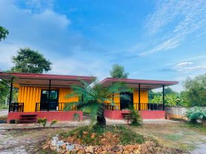 a home with a red and yellow house at The Monday ที่พักราคาถูก ใกล้หาดแหลมแม่พิมพ์ in Klaeng