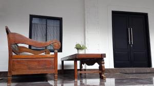 a chair and a table in front of a door at Rumah Benhil, Bendungan Hilir - Senayan in Jakarta