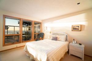 um quarto com uma cama e uma grande janela em Gene's Coastal Escape em Newport