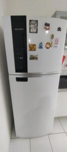 a white refrigerator with a bunch of magnets on it at Apto Shalom in Serra