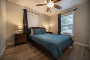 a bedroom with a bed and a ceiling fan at Just Beachy in Lincoln City