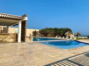 a swimming pool in front of a house at Victoria’s Beach house in Heroica Alvarado