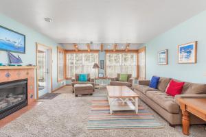 a living room with a couch and a fireplace at The Break in Pacific City