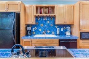a kitchen with wooden cabinets and a sink and a refrigerator at The Break in Pacific City +66 photos