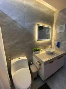 uma casa de banho com um WC branco e um lavatório. em The Sunset House em Lucban