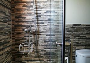 a shower with a glass door in a bathroom at SEVEN Hostal in Cala Millor