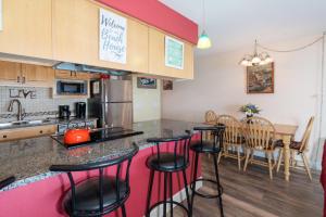 a kitchen and dining room with a counter and stools at Waters Edge 207 in Lincoln City