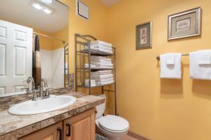 a bathroom with a sink and a toilet at Waters Edge 207 in Lincoln City +17 photos
