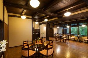 a dining room with a table and chairs at Yufuin Yufusaryo in Yufuin