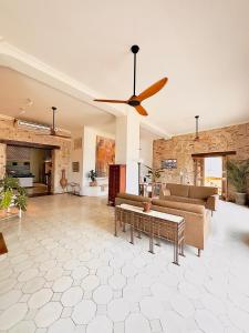 a living room with a couch and a ceiling fan at Amara Living in Cartagena de Indias