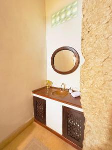 a bathroom with a sink and a mirror at Amara Living in Cartagena de Indias