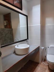 a bathroom with a sink and a toilet at D.R. Lanta Bay Resort in Ko Lanta