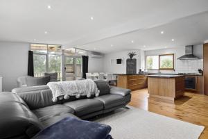 ein Wohnzimmer mit einem Sofa und einer Küche in der Unterkunft Rolig in Shoreham