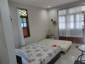 a bedroom with a bed and a window at Homestay Erna Tanjong Tinggi in Pasarbaru